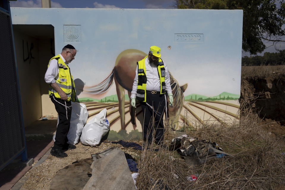 FILE - Volunteers from the ZAKA rescue service remove blood stains from a public bomb shelter on a road near the Israeli-Gaza border in the aftermath of the Oct. 7 Hamas attack, Nov. 20, 2023. Some allege the accounts of sexual assault were purposely concocted. Zaka officials and others dispute that. Regardless, AP’s examination of Zaka’s handling of the now debunked stories shows how information can be clouded and distorted in the chaos of the conflict. (AP Photo/Ohad Zwigenberg, File)