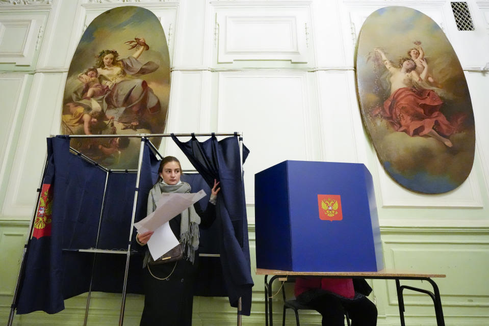A woman prepares to cast her ballot during the State Duma, the Lower House of the Russian Parliament and local parliaments elections at a polling station situated in an old palace in St. Petersburg, Russia, Saturday, Sept. 18, 2021. Sunday will be the last of three days voting for a new parliament, but there seems to be no expectation that United Russia, the party devoted to President Vladimir Putin, will lose its dominance in the State Duma. (AP Photo/Dmitri Lovetsky)