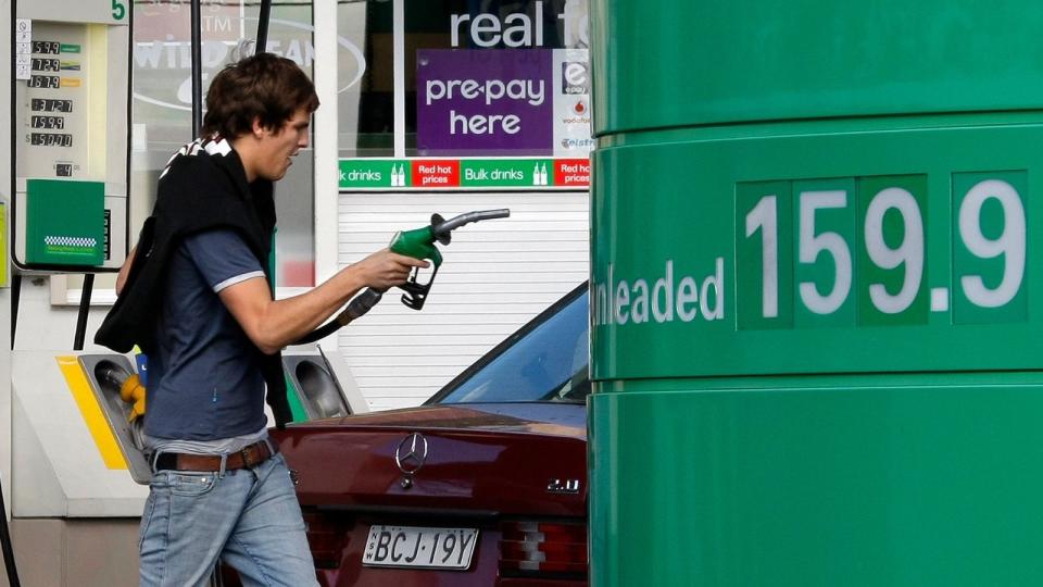 Man holding petrol pump at fuel station