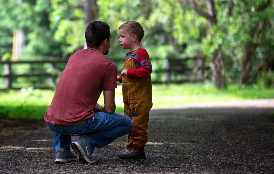 Jake Cassinari has a quiet moment with his son, Ever, 4, at their home in Springboro. Jake married Liz Pieniazek, now Cassinari, last August on the property. The couple have three children, Zoe, 6, LillyMae, 10, and Ever. They call Jake dad. Their daddy, Jordan Pieniazek, a Cincinnati firefighter, was killed May 1, 2016.