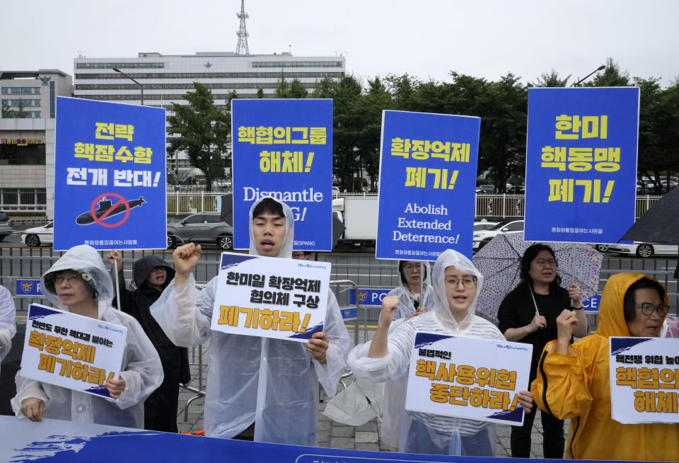 Protesters stage a rally against a meeting of Nuclear Consultative Group between South Korea and the United States in front of the presidential office in Seoul, South Korea, Tuesday, July 18, 2023. A bilateral consulting group of South Korean and U.S. officials met Tuesday in Seoul to discuss strengthening their nations' deterrence capabilities against North Korea's evolving nuclear threats. The signs read "Disintegration of Nuclear Consultative Group" (AP Photo/Ahn Young-joon)