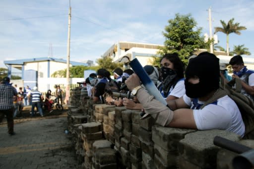 Anti-government protesters wait behind a barricade in support of "the Mothers of April" - whose children died in protests - on Nicaragua's National Mother?s Day in Managua