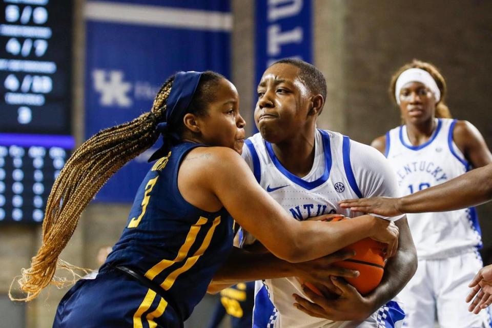 Kentucky Wildcats forward Dre’una Edwards (44) fights for control of the ball with West Virginia Mountaineers guard Kirsten Deans (3) during the game at Memorial Coliseum in Lexington, Ky., Wednesday, December 1, 2021. Edwards had her second straight double-double in the game, a 23-point UK win.