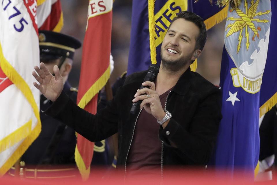 Country music singer Luke Bryan sings the National Anthem, before the NFL Super Bowl 51 football game between the New England Patriots and the Atlanta Falcons, Sunday, Feb. 5, 2017, in Houston. (AP Photo/Darron Cummings)