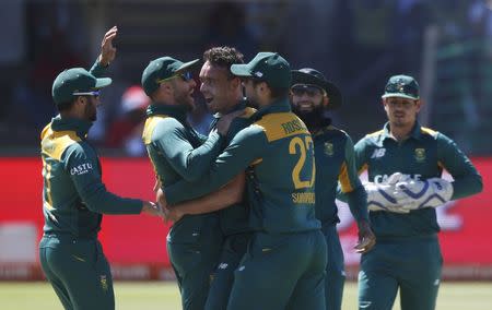 South Africa's Kyle Abbott (3rd L) celebrates with team-mates after dismissing England's Jason Roy during their second One-Day International cricket match in Port Elizabeth, February 6, 2016. REUTERS/Mike Hutchings