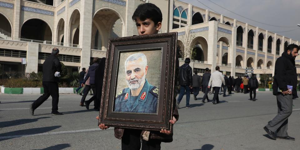 A boy carries a portrait of Iranian Revolutionary Guard Gen. Qassem Soleimani, who was killed in the U.S. airstrike in Iraq, prior to the Friday prayers in Tehran, Iran, Friday Jan. 3, 2020. Iran has vowed 