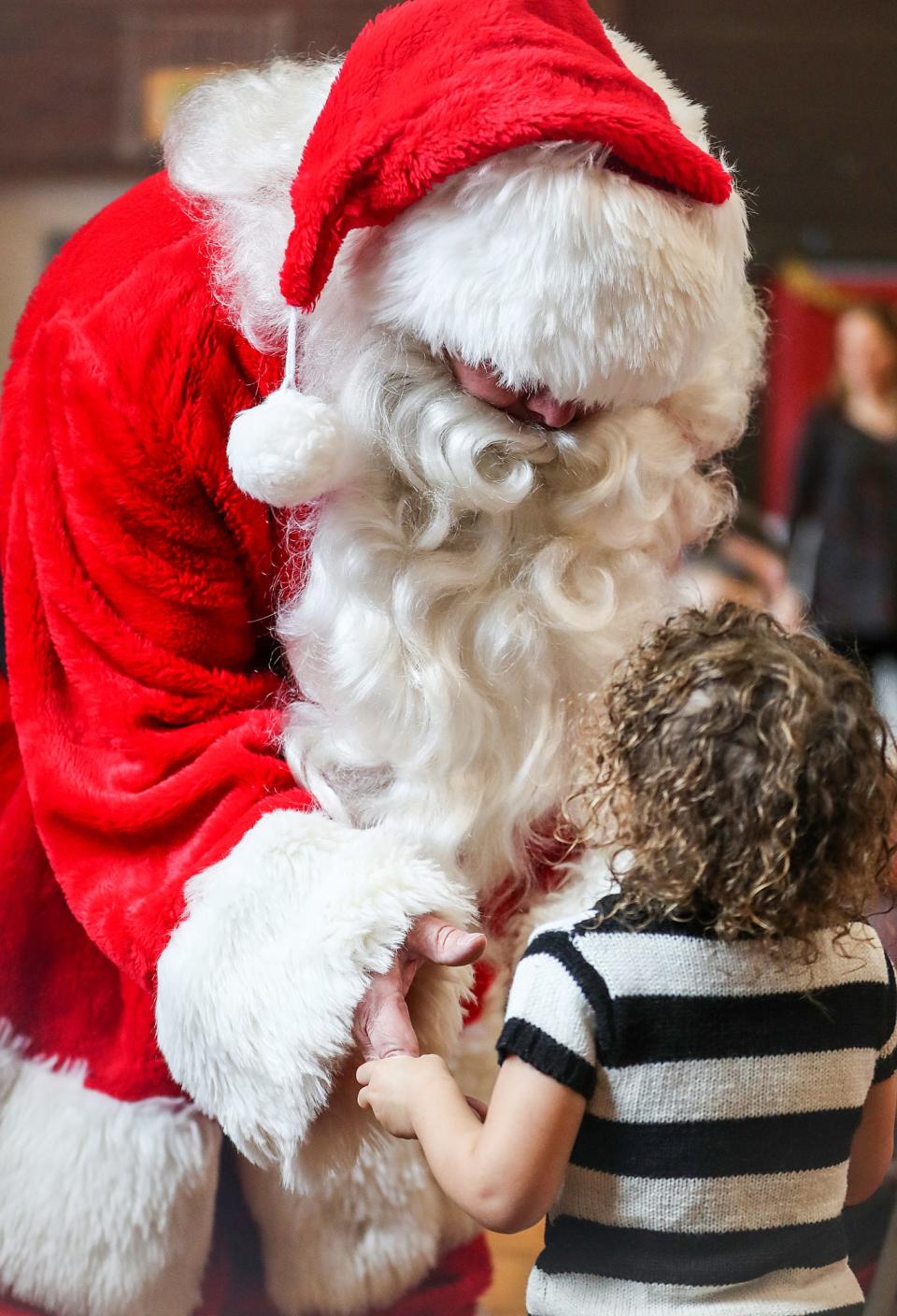Santa Claus greets a little one during the 4th annual Brunch with Santa hosted by Indy Parks at Christian Park in Indianapolis, Saturday, Dec. 22, 2018.