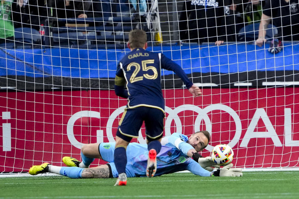 Seattle Sounders goalkeeper Stefan Frei makes a save against Vancouver Whitecaps midfielder Ryan Gauld (25) during the first half of an MLS soccer match Saturday, April 20, 2024, in Seattle. (AP Photo/Lindsey Wasson)