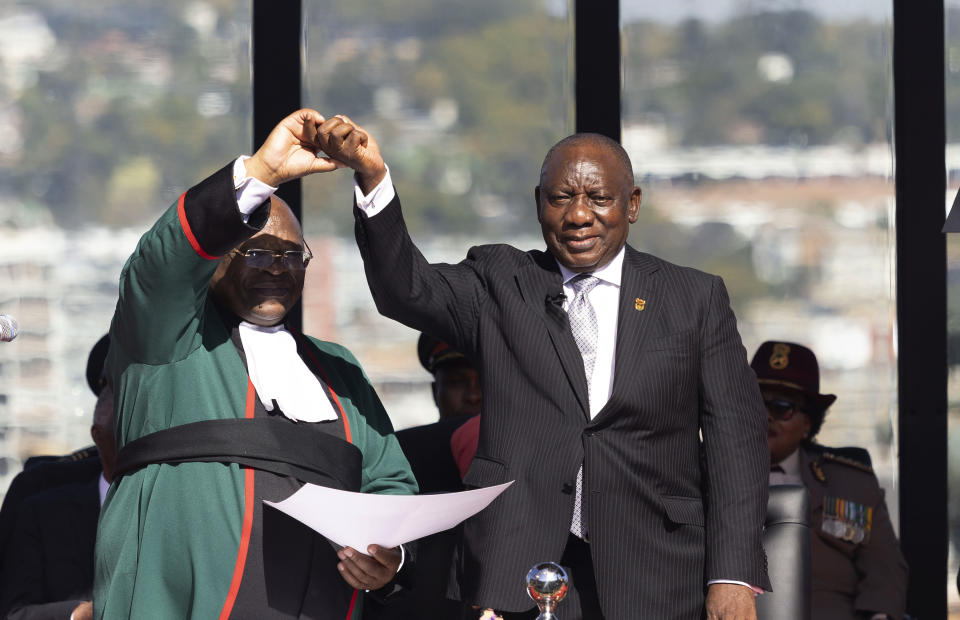 South Africa's Cyril Ramaphosa, is sworn in as President by Chief Justice Raymond Zondo, left, at his inauguration at the Union Buildings in Tshwane, South Africa, Wednesday, June 19, 2024. (Kim Ludbrook/Pool Photo via AP)