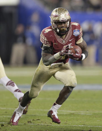FILE - In this Saturday, Dec. 6, 2014 file photo, Florida State&#39;s Dalvin Cook (4) runs against Georgia Tech during the second half of the Atlantic Coast Conference championship NCAA college football game in Charlotte, N.C. Florida State is suspending running back Dalvin Cook indefinitely after a woman accused him of punching her outside a downtown bar. The school announced the decision Friday, July 10, 2015 after the state attorney issued a warrant for Cook&#39;s arrest on a misdemeanor battery charge. (AP Photo/Chuck Burton, File
