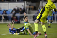 San Jose Earthquakes forward Benji Kikanovic, left, scores a goal over Seattle Sounders defender Shane O'Neill, center, and goalkeeper Stefan Frei (24) during the second half of an MLS soccer match Wednesday, Sept. 29, 2021, in San Jose, Calif. (AP Photo/Tony Avelar)