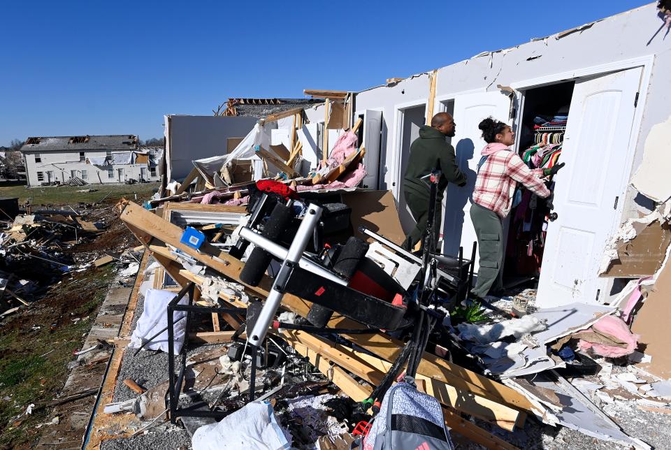 Dion Booker and his wife, Allison Booker, remove belongings from their damaged second floor West Creek apartment on Monday, Dec. 11, 2023, in Clarksville, Tenn. Tornadoes struck Middle Tennessee causing catastrophic damage and killing six people Saturday.