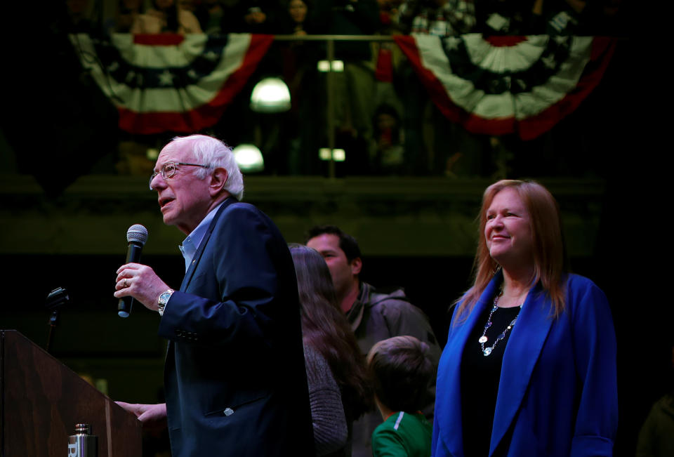 Sen. Bernie Sanders addresses a college town hall campaign as his wife, Jane, looks on 