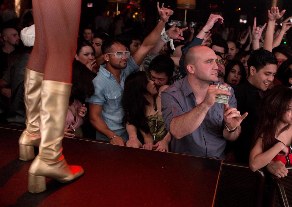 Revelers dance to the music played by DJ Afrojack inside the XS nightclub in Las Vegas on Sunday, Jan. 20, 2013. (AP Photo/Julie Jacobson)