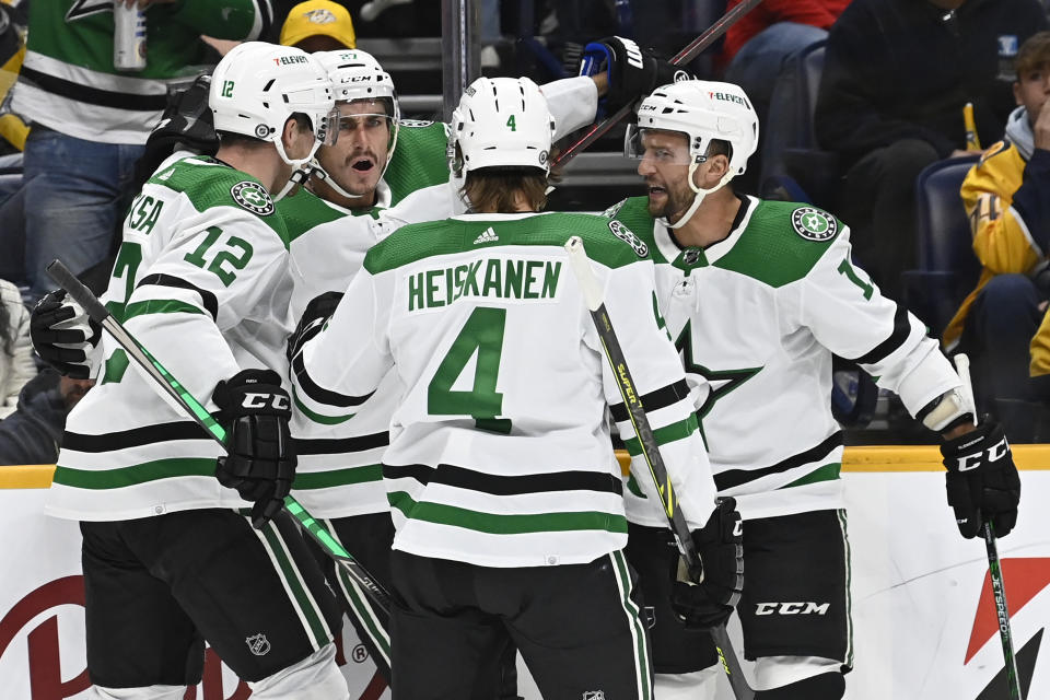 Dallas Stars left wing Mason Marchment, second from left, celebrates with teammates after scoring a goal against the Nashville Predators during the first period of an NHL hockey game Thursday, Oct. 13, 2022, in Nashville, Tenn. (AP Photo/Mark Zaleski)