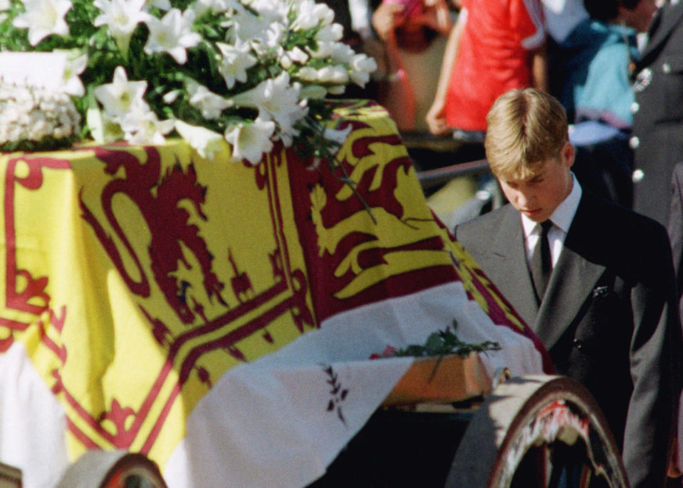 FILE - Prince William walks with his head bowed behind the coffin of his mother Diana, Princess of Wales, on its way to London's Westminster Abbey for a funeral ceremony, Saturday, Sept. 6, 1997. The world watched as Prince William grew from a towheaded schoolboy to a dashing air-sea rescue pilot to a father of three. But as he turns 40 on Tuesday, June 21, 2022, William is making the biggest change yet: assuming an increasingly central role in the royal family as he prepares for his eventual accession to the throne. (Ulli Michel/ Pool via AP, File)