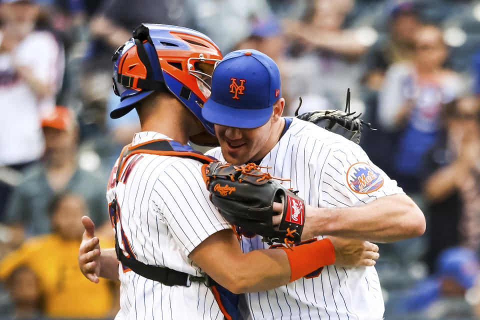 New York Mets' relief pitcher Trevor May hugs catcher Tomas Nido after they defeated the Pittsburgh Pirates in a baseball game, Sunday, Sept. 18, 2022, in New York. (AP Photo/Julia Nikhinson)