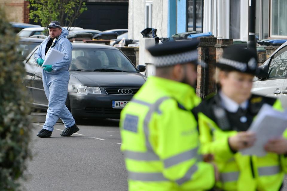 Police and forensics investigating a stabbing in Edmonton earlier this year (PA)