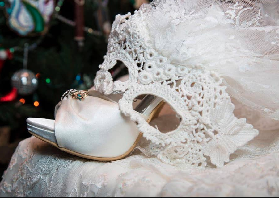 Bridal white shoes and a white lace mask