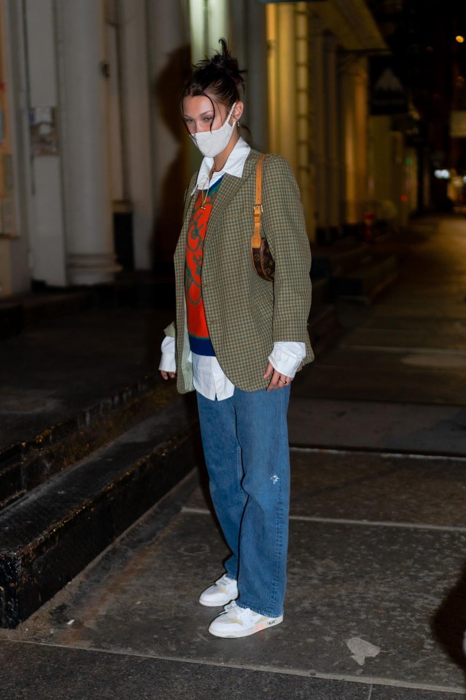 Bella in Soho wearing a plaid blazer and jeans