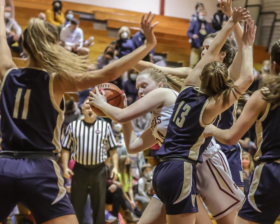 Portsmouth's Maddie MacCannell makes a move in the paint with heavy pressure from Windham's Alexa Bean (13) and Hannah Smith (11) during Friday's Division I girls basketball quarterfinal game at Stone Gymnasium.