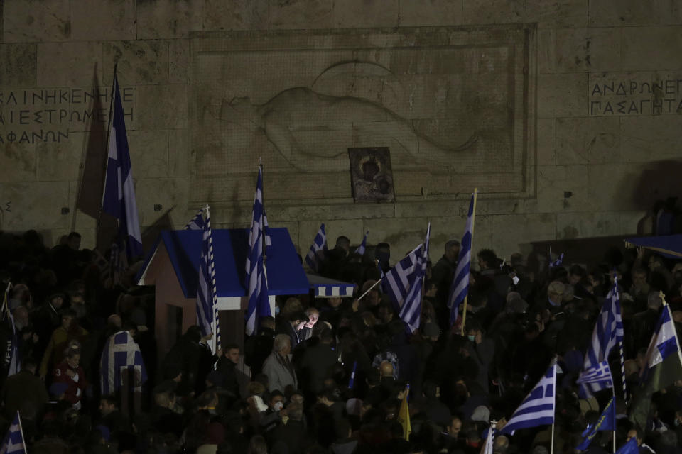 Opponents of Prespa Agreement gathering at the Tomb of the Unknown Soldier as they leave an Orthodox icon with Jesus and his mother Maria on, outside the Greek Parliament during a rally in Athens, Thursday, Jan. 24, 2019. Greek lawmakers are debating a historic agreement aimed at normalizing relations with Macedonia in a stormy parliamentary session scheduled to culminate in Friday vote. (AP Photo/Petros Giannakouris)