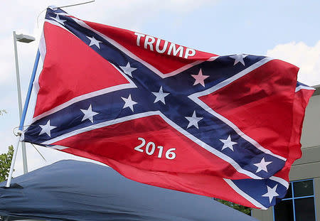 FILE PHOTO: A vendor flies the confederate flag prior to a Republican U.S. presidential candidate Donald Trump rally in Pittsburgh, June 11, 2016. REUTERS/Aaron Josefczyk/File Photo