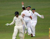 Members of South Africa celebrate the wicket of New Zealand's Martin Guptill during the second day of their first cricket test match in Durban, South Africa, August 20, 2016. REUTERS/Rogan Ward