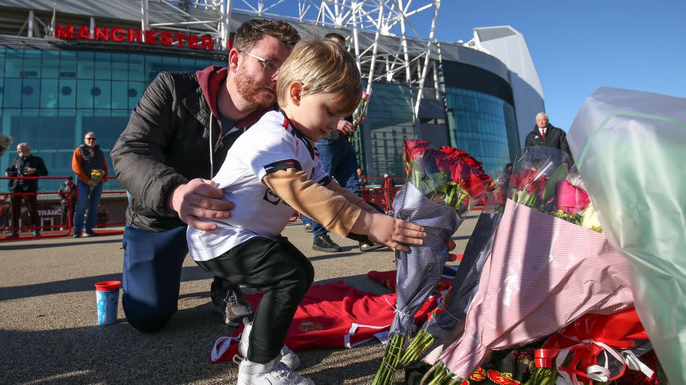 Flowers are placed in memory of Bobby Charlton beside the "United Trinity" statue at Old Trafford. - Barrington Coombs/PA Images/Getty Images