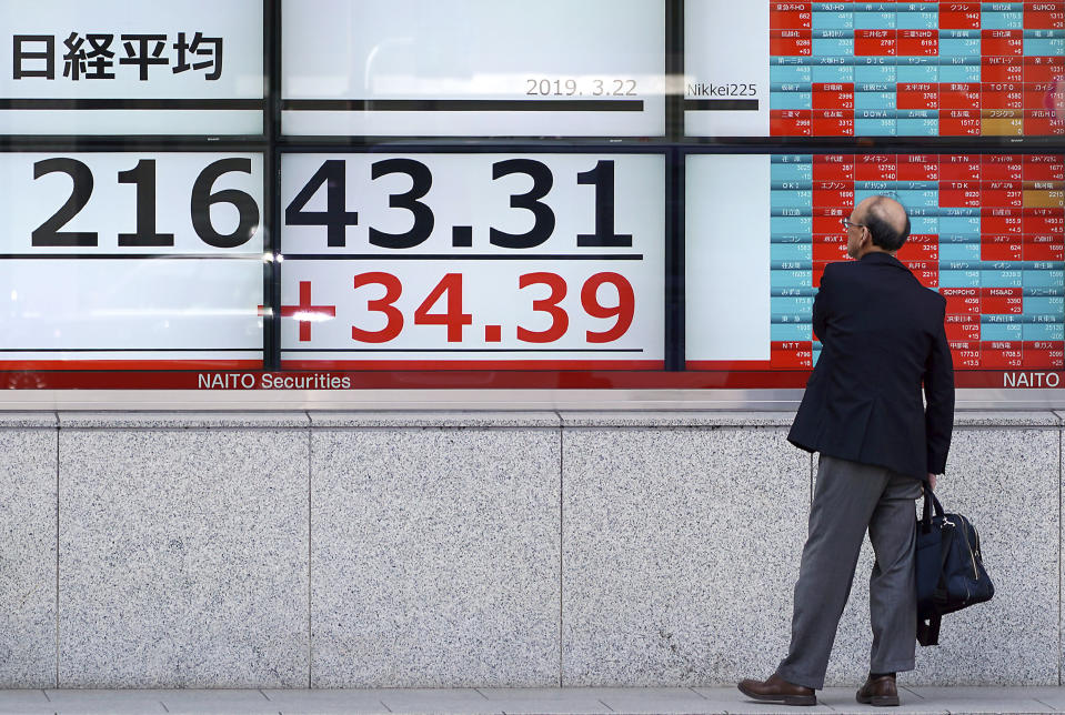 A man looks at an electronic stock board showing Japan's Nikkei 225 index at a securities firm in Tokyo Friday, March 22, 2019. Asian markets were mostly lower on Friday as investors mulled over the possibility of a trade deal between the U.S. and China in the near future, ahead of the continuation of talks in Beijing next week. (AP Photo/Eugene Hoshiko)