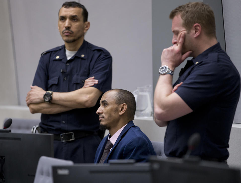 In this Wednesday April 4, 2018, file image, alleged jihadist leader Al Hassan Ag Abdoul Aziz Ag Mohamed Ag Mahmoud, center, takes his seat in the court room for his initial appearance on charges of war crimes and crimes against humanity at the International Criminal Court in The Hague, Netherlands. International Criminal Court judges rejected Wednesday an appeal by an alleged Islamic extremist from Mali who claimed the charges against him were not serious enough to merit standing trial at the global court. The decision clears the way for the trial of Al Hassan Ag Abdoul Aziz Ag Mohamed Ag Mahmoud to start later this year for alleged crimes in Timbuktu including torture, rape and persecution. (AP Photo/Peter Dejong, Pool)