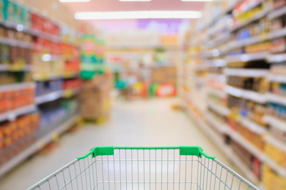 A grocery cart moving through the aisle.