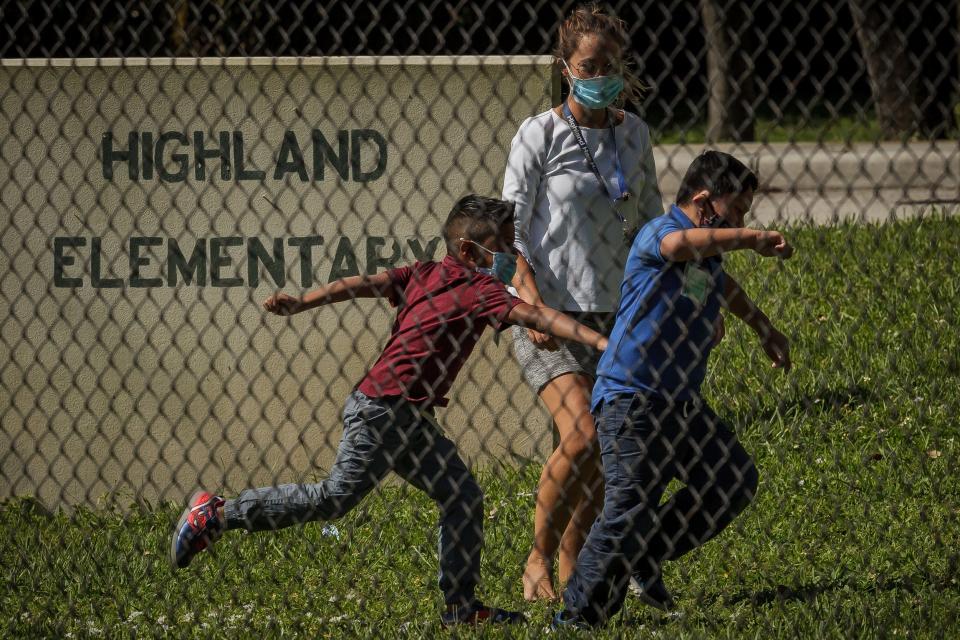First grade teacher Laura Seaman leads games of hide-and-seek and red light green light at Highland Elementary School in Lake Worth Beach in 2020.