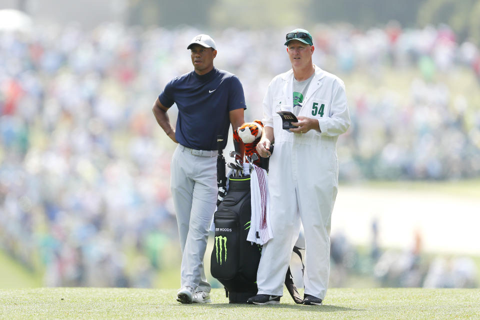 Tiger Woods speaks with caddie Joe LaCava at the Masters.