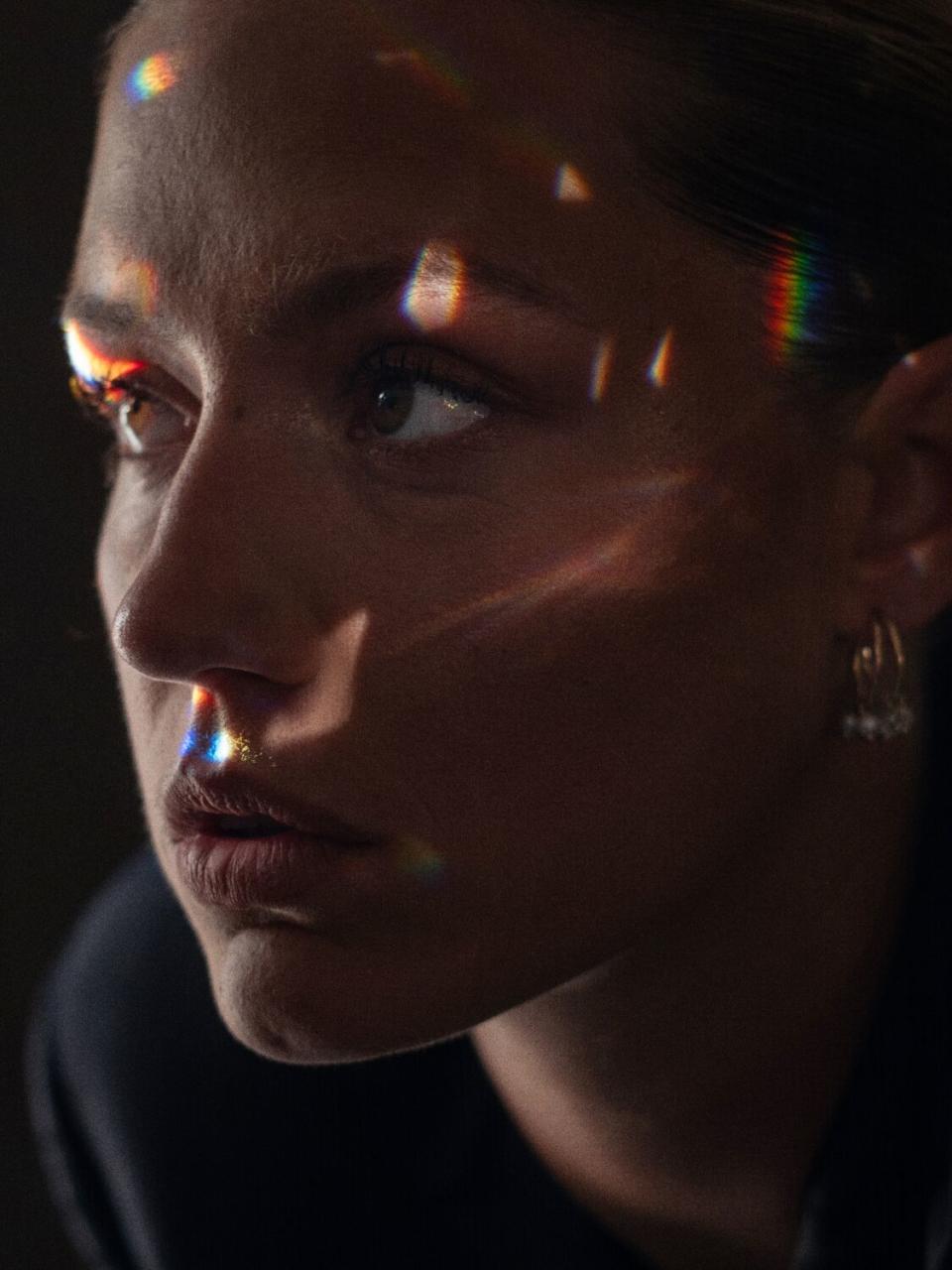 A woman has light reflected off her face