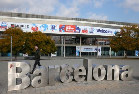 FILE PHOTO: A man walks past a typeface sculpture in front of an entrance of the Mobile World Congress in Barcelona, Spain, February 22, 2018.  REUTERS/Albert Gea/File Photo