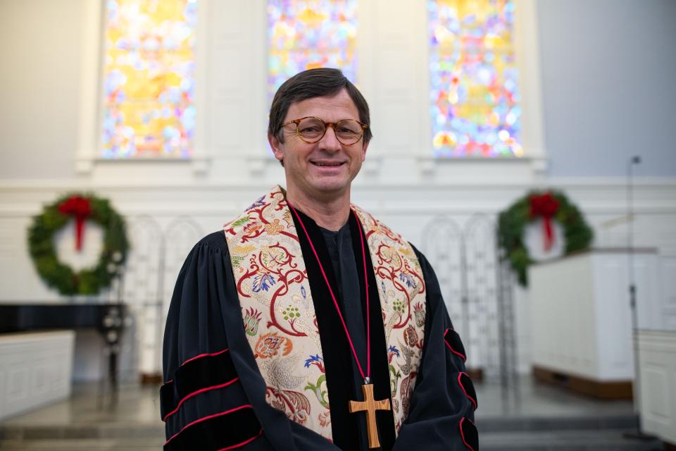 Rev. Dr. Matthew Williams poses in the Trinity United Methodist Church sanctuary Wednesday, Dec. 20, 2023.