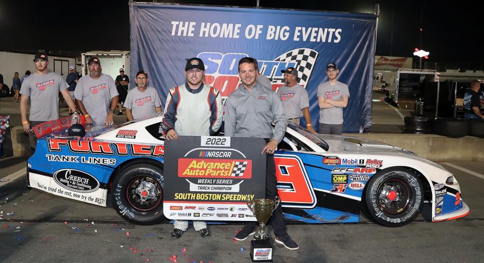 Layne Riggs of Bahama, North Carolina, surrounded by team members (front, left) is congratulated by South Boston Speedway General Manager Chase Brashears (front, right) after winning the 2022 South Boston Speedway NASCAR Advance Auto Parts Weekly Series Late Model Stock Car Division championship on Sept. 3. The championship is Riggs‘ first South Boston Speedway NASCAR track championship. Riggs finished second in both of the twin 65-lap NASCAR Advance Auto Parts Weekly Series Late Model Stock Car Division races that highlighted Saturday night‘s Halifax County Farm Bureau Championship Night event at South Boston Speedway. (Joe Chandler/South Boston Speedway)