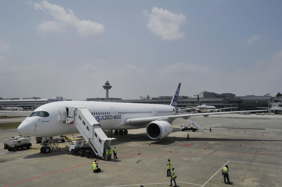 An Airbus A350-900 test plane is seen at Singapore's Changi Airport at a media preview ahead of the upcoming Singapore Air Show on Monday, Feb. 10, 2014. Airbus is showing off its new wide-body A350 at Asia's biggest airshow this week. It's a strong sign the European plane maker is on schedule to start delivering the advanced jet to airline customers in the second half of the year. (AP Photo/Joseph Nair)