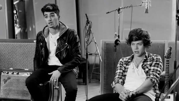 Zayn and Harry from One Direction sit in a recording studio in a black and white screenshot
