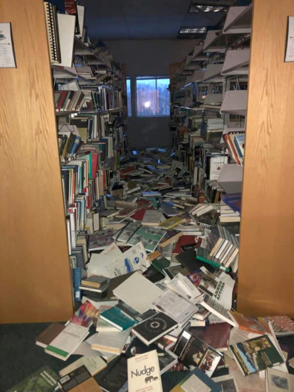 In this image courtesy of Dr. Holy A. Bell, books and ceiling tiles litter the floor at the The Mat-Su College library in Anchorage, Alaska, following an earthquake