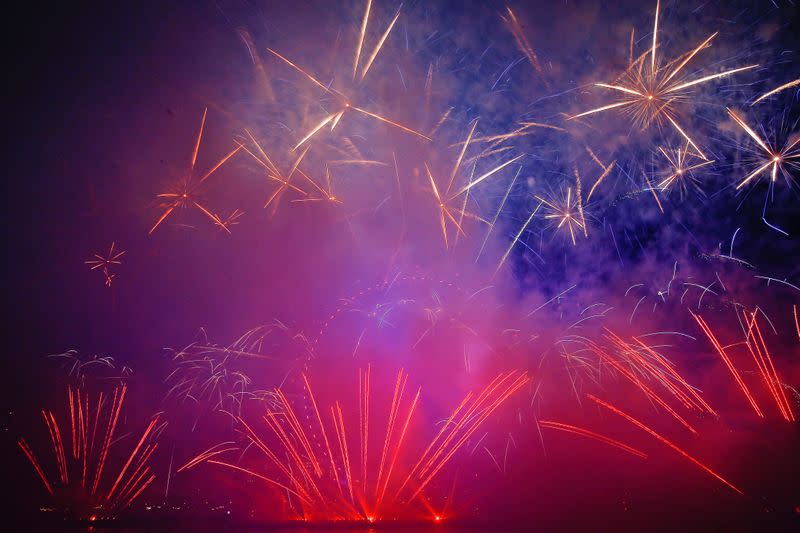 Fireworks explode over the London Eye wheel during New Year celebrations in central London