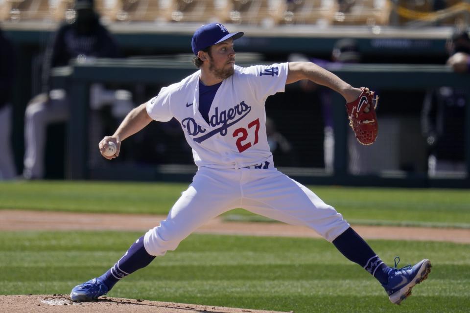 FILE - In this Monday, March 1, 2021, file photo, Los Angeles Dodgers starting pitcher Trevor Bauer throws against the Colorado Rockies during the first inning of a spring training baseball game in Phoenix. Dodgers pitcher Trevor Bauer is the highest-paid player in 2021 at $38 million after agreeing to a $102 million, three-year contract he can terminate after one season. (AP Photo/Ross D. Franklin, File)