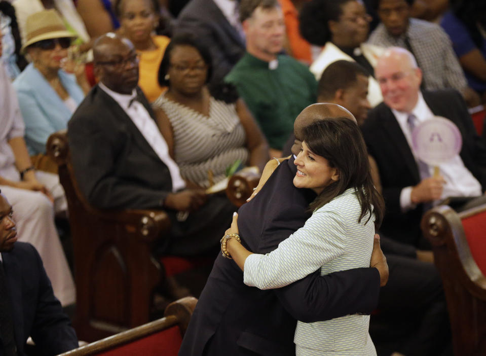  South Carolina Gov. Nikki Haley embraces U.S. Sen Tim Scott, R-S.C., at the Emanuel A.M.E. Church on June 21, 2015, four days after a mass shooting that claimed the lives of the Rev. Clementa Pinckney, a state senator, and eight worshippers at the historic Emanuel African Methodist Church in Charleston, South Carolina. Church elders decided to hold the regularly scheduled Sunday school and worship service as they continue to grieve the shooting death of nine of its members. (File/David Goldman-Pool/Getty Images)