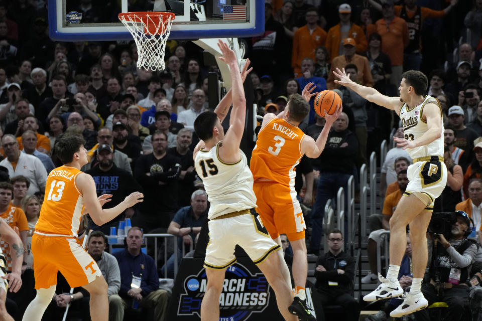 Tennessee guard Dalton Knecht (3) attempts a basket as Purdue center Zach Edey (15) and forward Camden Heide (23) defend during the second half of an Elite Eight college basketball game in the NCAA Tournament, Sunday, March 31, 2024, in Detroit. (AP Photo/Paul Sancya)