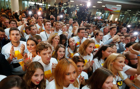 People at the Christian Democratic Union (CDU) headquarters react on first exit polls in the German general election (Bundestagswahl) in Berlin, Germany, September 24, 2017. REUTERS/Fabrizio Bensch