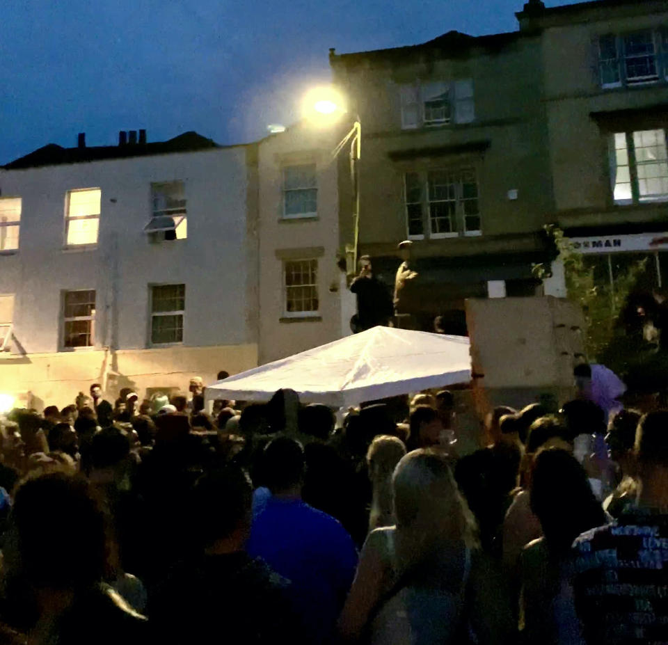 Hundreds of revellers took to a residential street in Stokes Croft, Bristol, for an all-night rave. (SWNS)