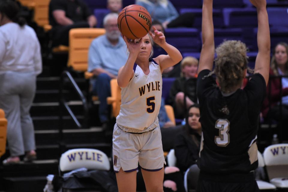 Wylie's Camri Travis (5) takes a 3-point shot during Tuesday's game against Lubbock High at Bulldog Gym on Jan. 18, 2022. Travis scored eight points in the second quarter as the Lady Bulldogs pulled away for an eventual 50-38 victory, their first in District 4-5A play.