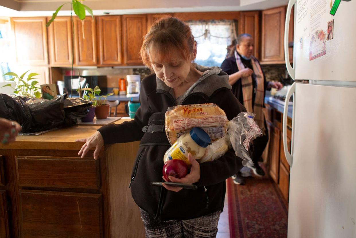 <span class="caption">Two women in late February at a Paterson, N.J. shelter for women who have suffered domestic violence.</span> <span class="attribution"><a class="link " href="https://www.gettyimages.com/detail/news-photo/brigitte-carries-food-from-the-kitchen-of-the-shelter-news-photo/1231521896?adppopup=true" rel="nofollow noopener" target="_blank" data-ylk="slk:Kena Betancur/AFP/Getty Images;elm:context_link;itc:0;sec:content-canvas">Kena Betancur/AFP/Getty Images</a></span>