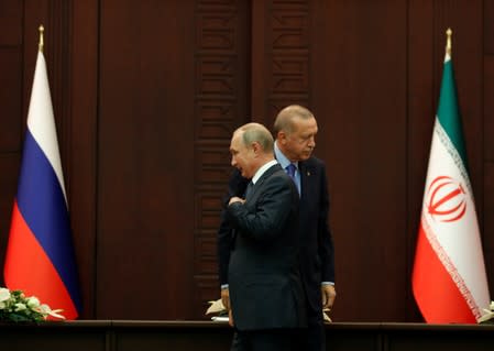 Russian President Putin and his Turkish counterpart Erdogan leave after a joint news conference in Ankara